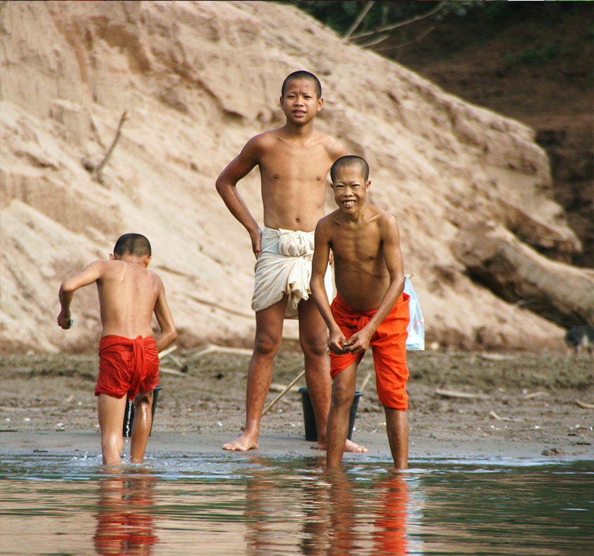 Monks showering in the Nam Ou River, close to Muang Ngoi